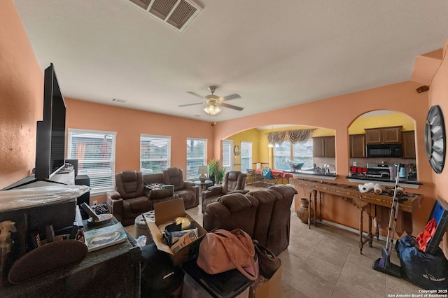 5602 Casa Martin, Katy, TX 77449 - living area featuring arched walkways, ceiling fan, and light tile patterned flooring