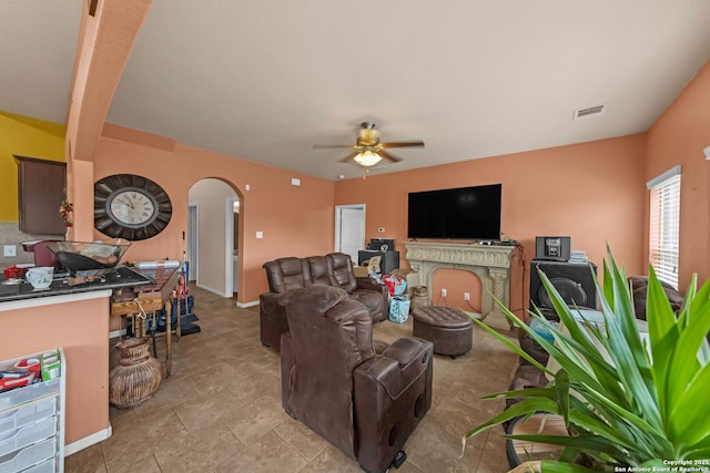 5602 Casa Martin, Katy, TX 77449 - living room featuring arched walkways, a ceiling fan, and baseboards