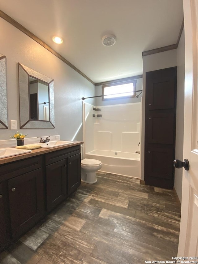 1727 Fm 1346, La Vernia, TX 78121 - bathroom with ornamental molding, tub / shower combination, double vanity, wood finished floors, and toilet