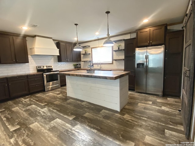 1727 Fm 1346, La Vernia, TX 78121 - kitchen with appliances with stainless steel finishes, open shelves, custom exhaust hood, butcher block countertops, and dark brown cabinets