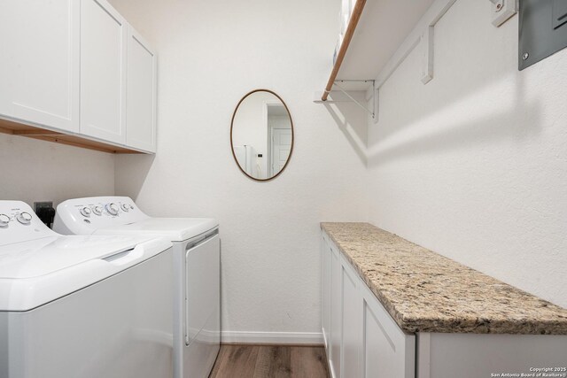 10128 Bussang, Schertz, TX 78154 - laundry room featuring washing machine and clothes dryer, baseboards, wood finished floors, and cabinet space