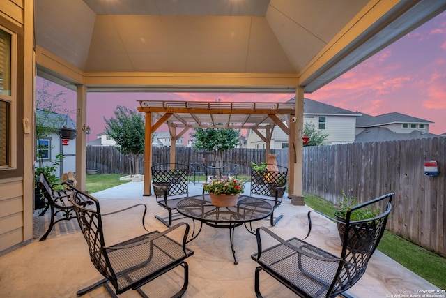 10128 Bussang, Schertz, TX 78154 - patio terrace at dusk featuring a pergola, outdoor dining area, a patio area, and a fenced backyard