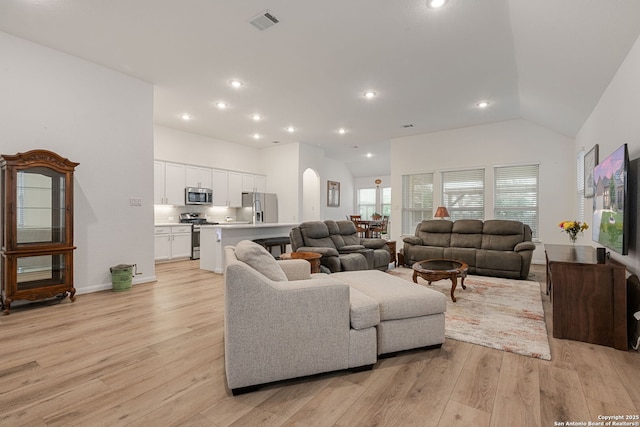 10128 Bussang, Schertz, TX 78154 - living room with light wood-type flooring, vaulted ceiling, recessed lighting, baseboards, and arched walkways