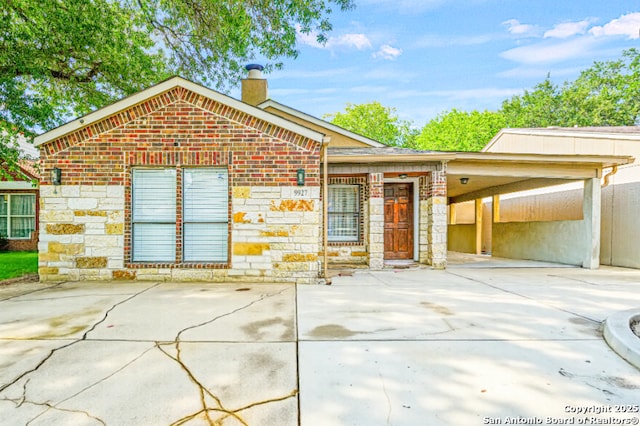 9927 Sandy Fld, San Antonio, TX 78245 - view of front of house with a chimney, stone siding, and brick siding