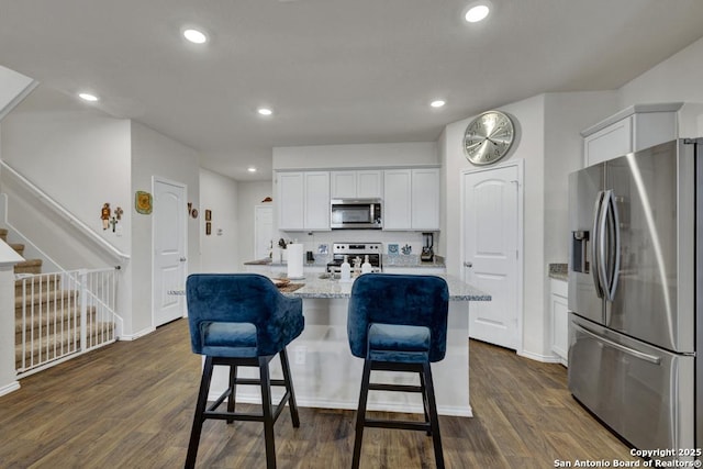 437 Signe, Seguin, TX 78155 - kitchen with stainless steel appliances, dark wood-style flooring, white cabinets, an island with sink, and recessed lighting