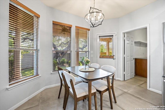 2630 Starlight Ct, San Antonio, TX 78261 - dining area with a chandelier, baseboards, and light tile patterned floors