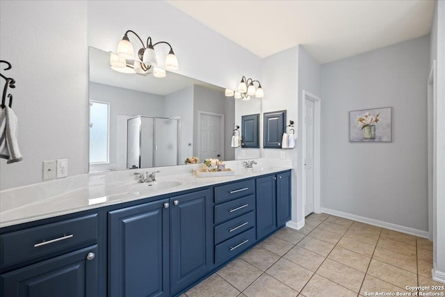 2630 Starlight Ct, San Antonio, TX 78261 - bathroom with double vanity, a stall shower, tile patterned floors, baseboards, and a chandelier