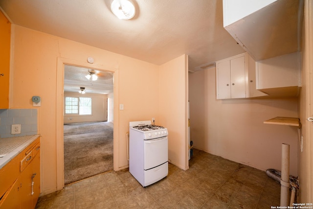 115 Elmo, San Antonio, TX 78225 - kitchen with white gas range oven, light countertops, light floors, and white cabinetry