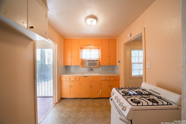 115 Elmo, San Antonio, TX 78225 - kitchen with white gas range oven, healthy amount of natural light, and cooling unit