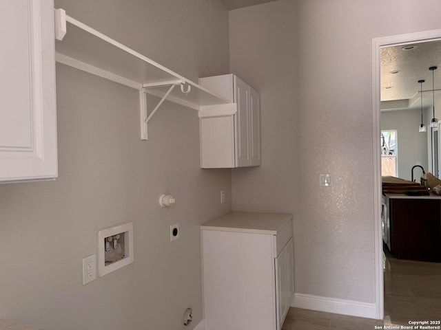 15609 Fox Ln, Selma, TX 78154 - washroom featuring electric dryer hookup, washer hookup, baseboards, cabinet space, and gas dryer hookup