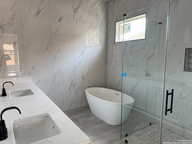 15609 Fox Ln, Selma, TX 78154 - full bath featuring tile walls, a shower stall, a freestanding tub, and double vanity
