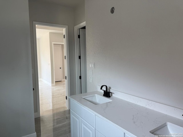 15609 Fox Ln, Selma, TX 78154 - bathroom with double vanity and baseboards