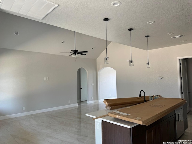 15609 Fox Ln, Selma, TX 78154 - kitchen with arched walkways, open floor plan, ceiling fan, decorative light fixtures, and a textured ceiling