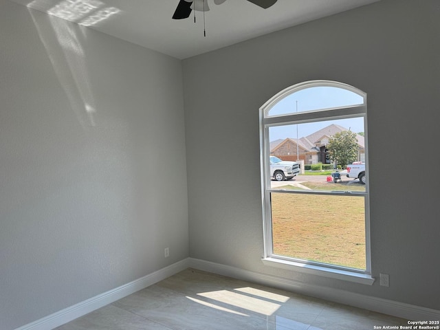 15609 Fox Ln, Selma, TX 78154 - empty room with ceiling fan, baseboards, and tile patterned flooring