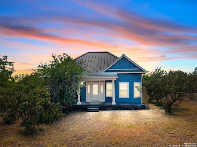 377 County Road 444, Hondo, TX 78861 - view of front facade with a standing seam roof, metal roof, and a porch