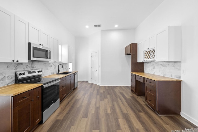 377 County Road 444, Hondo, TX 78861 - kitchen with appliances with stainless steel finishes, a sink, butcher block counters, white cabinets, and dark wood-style flooring