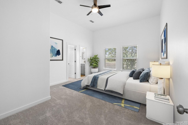 377 County Road 444, Hondo, TX 78861 - carpeted bedroom featuring baseboards, ensuite bath, and ceiling fan