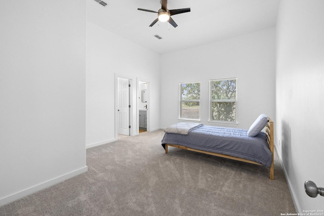 377 County Road 444, Hondo, TX 78861 - carpeted bedroom with baseboards, a towering ceiling, a ceiling fan, and ensuite bathroom