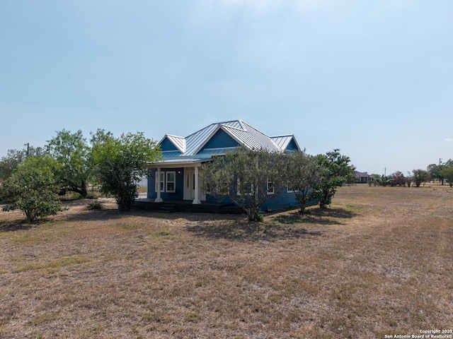 377 County Road 444, Hondo, TX 78861 - view of front of property featuring a standing seam roof, a porch, metal roof, and a front yard