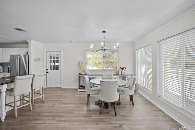 220 Glenvalley, Bandera, TX 78003 - dining space featuring a chandelier, baseboards, ornamental molding, and light wood-style flooring