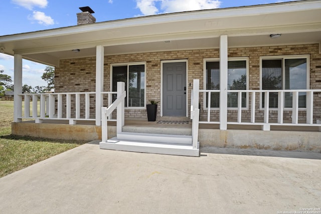 220 Glenvalley, Bandera, TX 78003 - entrance to property with a porch, a chimney, and brick siding