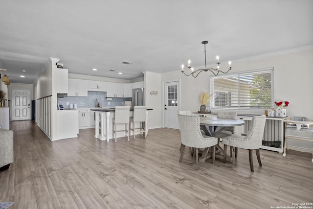 220 Glenvalley, Bandera, TX 78003 - dining space with a chandelier, ornamental molding, light wood-style flooring, and recessed lighting
