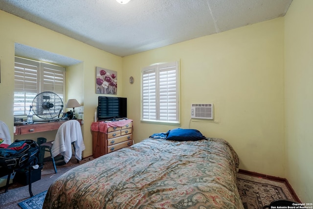 1230 Churing, San Antonio, TX 78245 - bedroom featuring multiple windows, carpet floors, baseboards, a textured ceiling, and a wall mounted AC