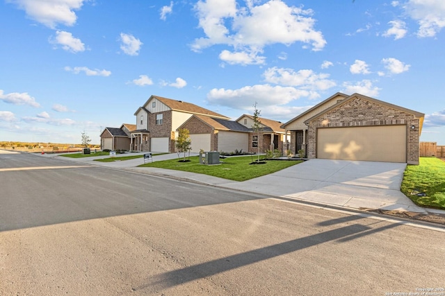 4267 Winston Way, New Braunfels, TX 78130 - view of front of house with brick siding, driveway, an attached garage, and a front yard