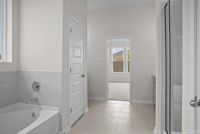 13442 Cosette Xing, San Antonio, TX 78253 - bathroom with a garden tub, tile patterned flooring, baseboards, vanity, and a shower with door