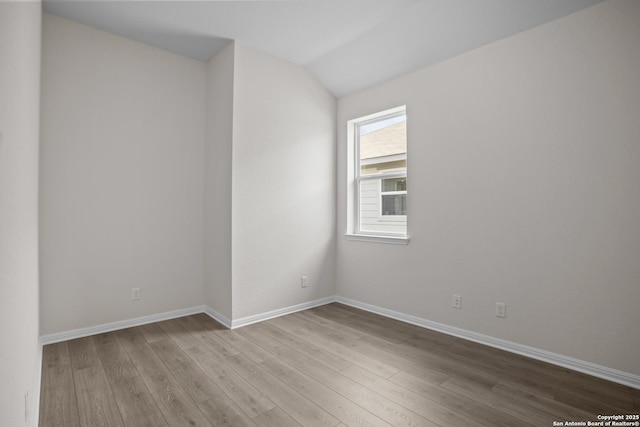 13442 Cosette Xing, San Antonio, TX 78253 - unfurnished room with wood finished floors, baseboards, and vaulted ceiling