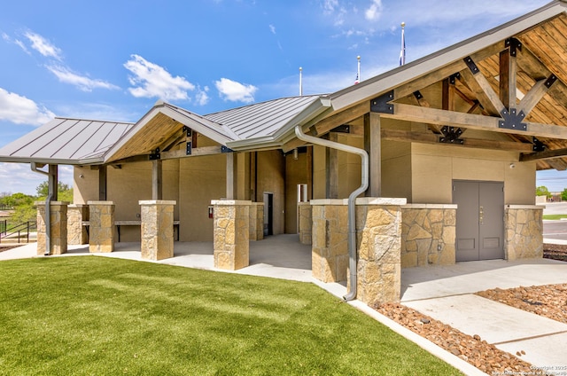 13442 Cosette Xing, San Antonio, TX 78253 - view of front of home with a standing seam roof, stone siding, metal roof, a front lawn, and stucco siding