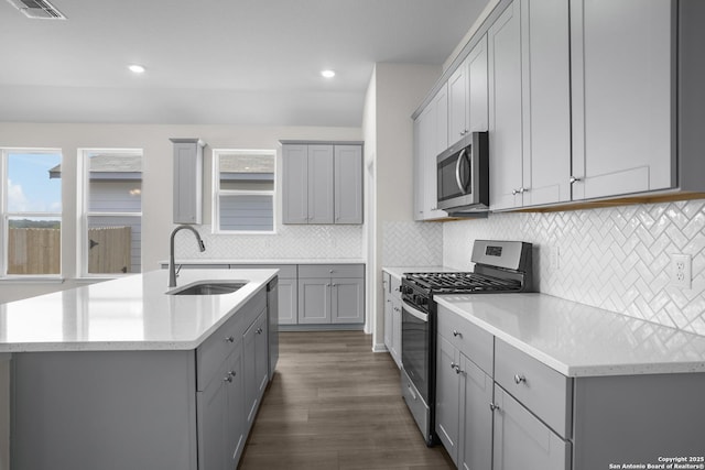 13442 Cosette Xing, San Antonio, TX 78253 - kitchen featuring stainless steel appliances, a sink, gray cabinetry, dark wood-style flooring, and recessed lighting