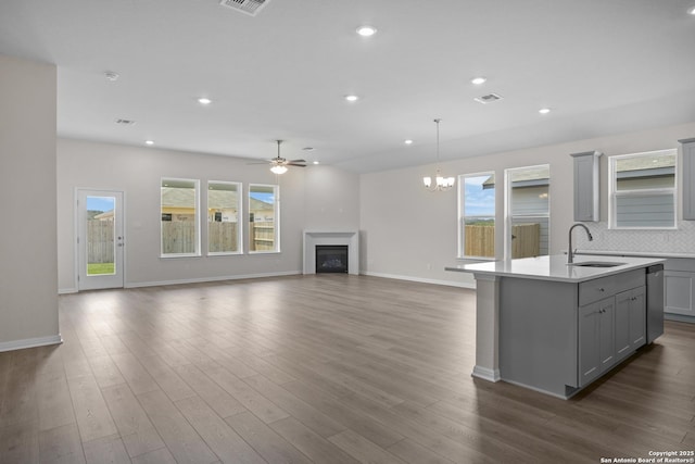13442 Cosette Xing, San Antonio, TX 78253 - kitchen featuring gray cabinets, a sink, a center island with sink, a ceiling fan, and light countertops