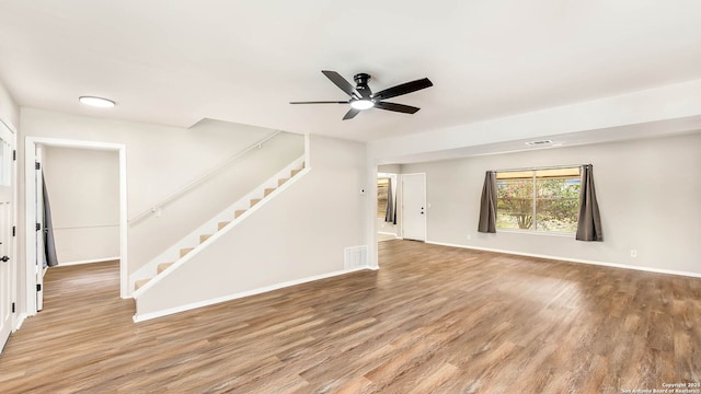 2130 Fort Sumter, San Antonio, TX 78245 - unfurnished living room with stairway, a ceiling fan, light wood-style floors, and baseboards