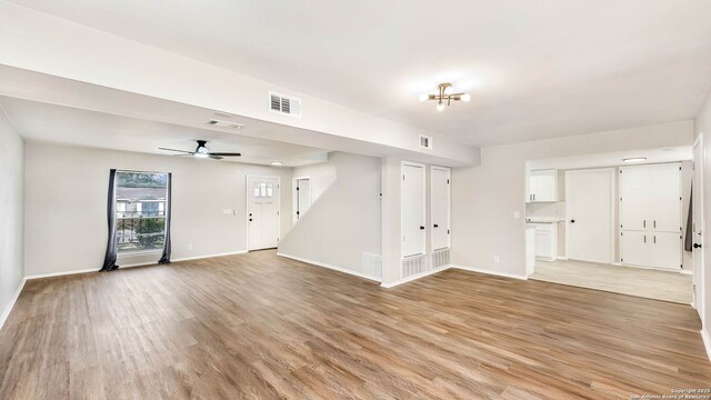 2130 Fort Sumter, San Antonio, TX 78245 - unfurnished living room featuring light wood-style floors, baseboards, and a ceiling fan