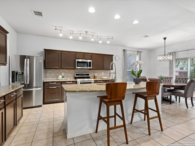 627 Midway, San Antonio, TX 78258 - kitchen with stainless steel appliances, decorative backsplash, a sink, plenty of natural light, and recessed lighting