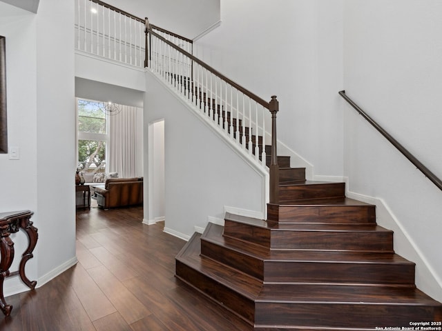 627 Midway, San Antonio, TX 78258 - stairway with wood finished floors, a chandelier, baseboards, and a high ceiling