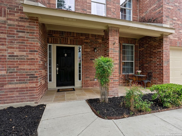 627 Midway, San Antonio, TX 78258 - doorway to property featuring brick siding, a garage, and a porch