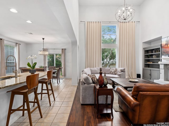 627 Midway, San Antonio, TX 78258 - living room featuring a chandelier, healthy amount of natural light, recessed lighting, a high ceiling, and light wood-style flooring