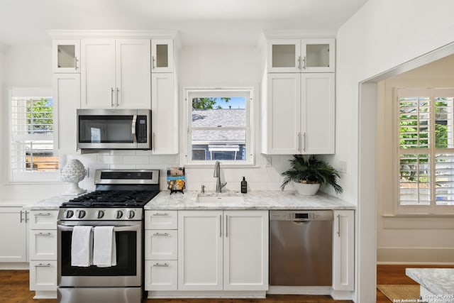 418 Eleanor, San Antonio, TX 78209 - kitchen with stainless steel appliances, a sink, white cabinets, and tasteful backsplash