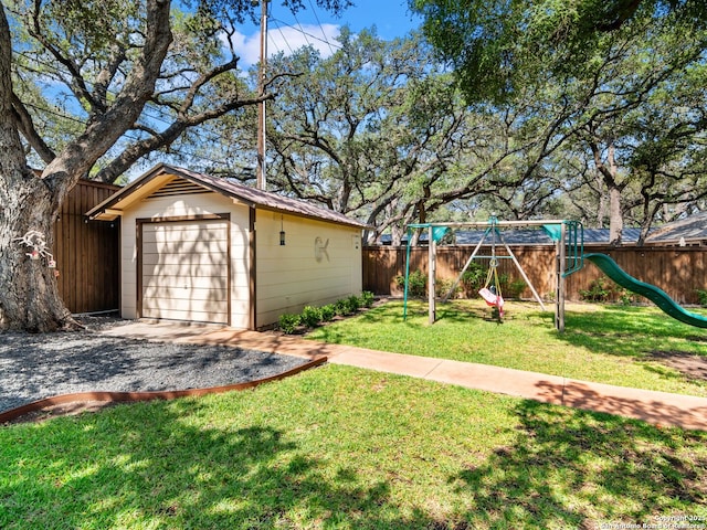 134 Camellia Way, San Antonio, TX 78209 - view of yard with a playground, driveway, an outbuilding, and a garage