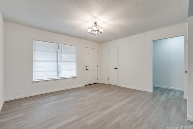 7126 Westbriar, San Antonio, TX 78227 - spare room with a chandelier, light wood-style flooring, and baseboards