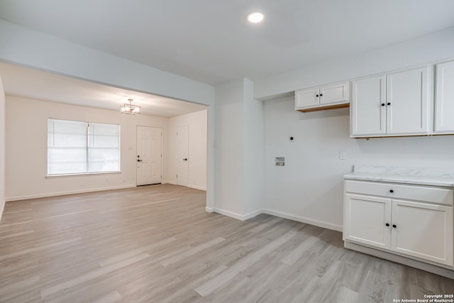 7126 Westbriar, San Antonio, TX 78227 - kitchen with white cabinetry, light wood-type flooring, baseboards, light stone countertops, and a chandelier