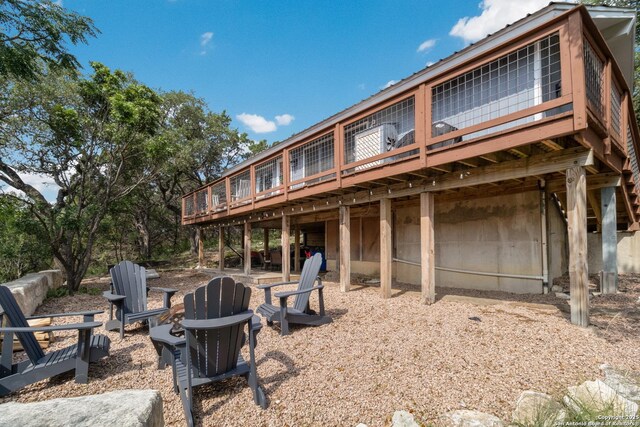 577 Dusty Saddle, Canyon Lake, TX 78133 - rear view of house featuring an outdoor fire pit and a wooden deck