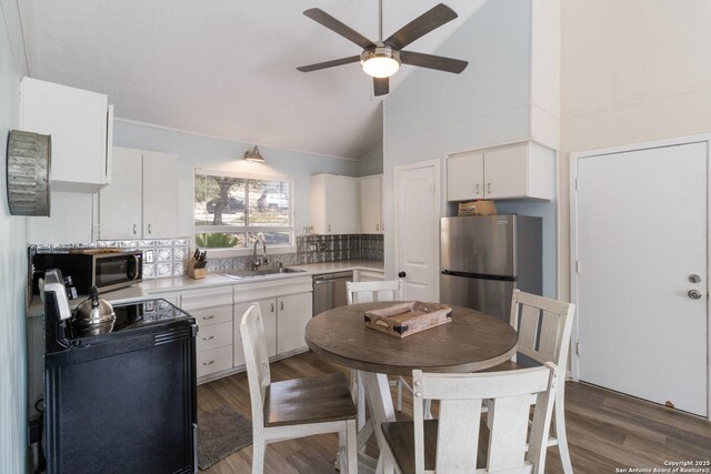 577 Dusty Saddle, Canyon Lake, TX 78133 - kitchen featuring stainless steel appliances, a sink, a ceiling fan, high vaulted ceiling, and white cabinetry