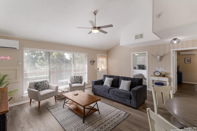577 Dusty Saddle, Canyon Lake, TX 78133 - living room with a wall mounted air conditioner, wood finished floors, a ceiling fan, vaulted ceiling, and baseboards