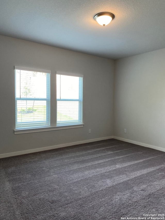 759 Fort Leonard, San Antonio, TX 78245 - empty room featuring plenty of natural light, dark carpet, and baseboards