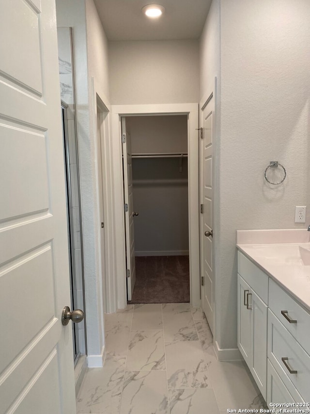 759 Fort Leonard, San Antonio, TX 78245 - bathroom featuring a spacious closet, vanity, marble finish floors, baseboards, and recessed lighting
