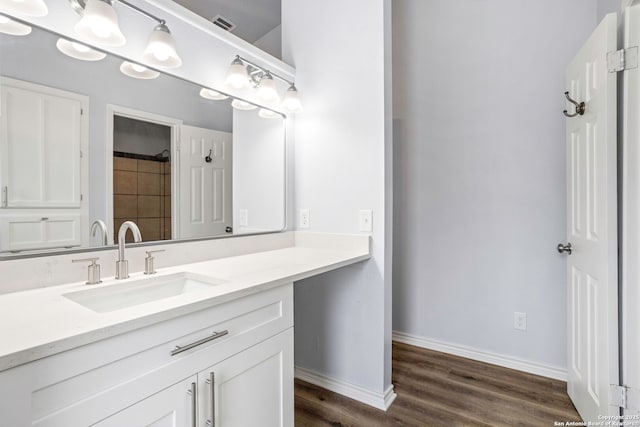 11403 Big Elk, San Antonio, TX 78245 - bathroom featuring vanity, wood finished floors, baseboards, and a shower