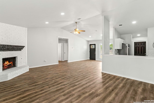 11403 Big Elk, San Antonio, TX 78245 - unfurnished living room with a brick fireplace, ceiling fan, dark wood-style floors, lofted ceiling, and baseboards